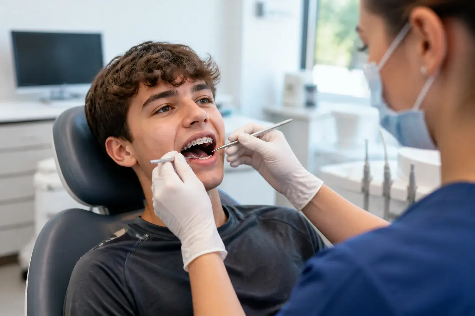 Sports mouthguard next to braces model showing protection for athletes wearing brackets during games