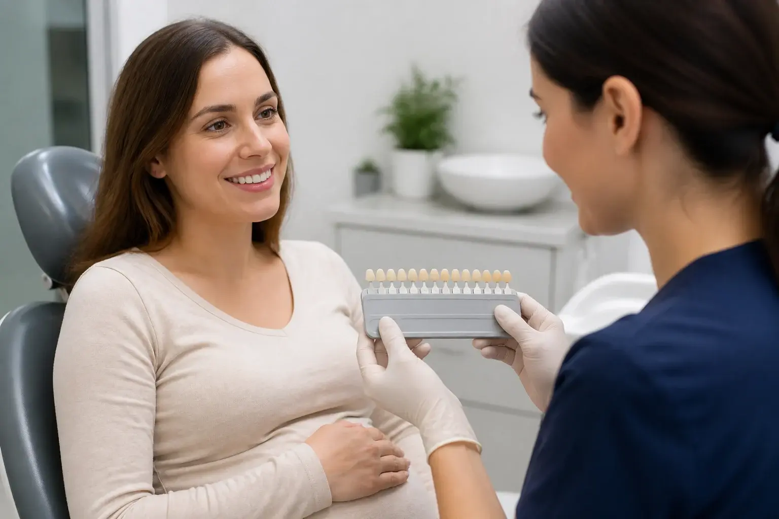 Dentist reviewing a whitening shade guide with a pregnant patient during a safety consultation