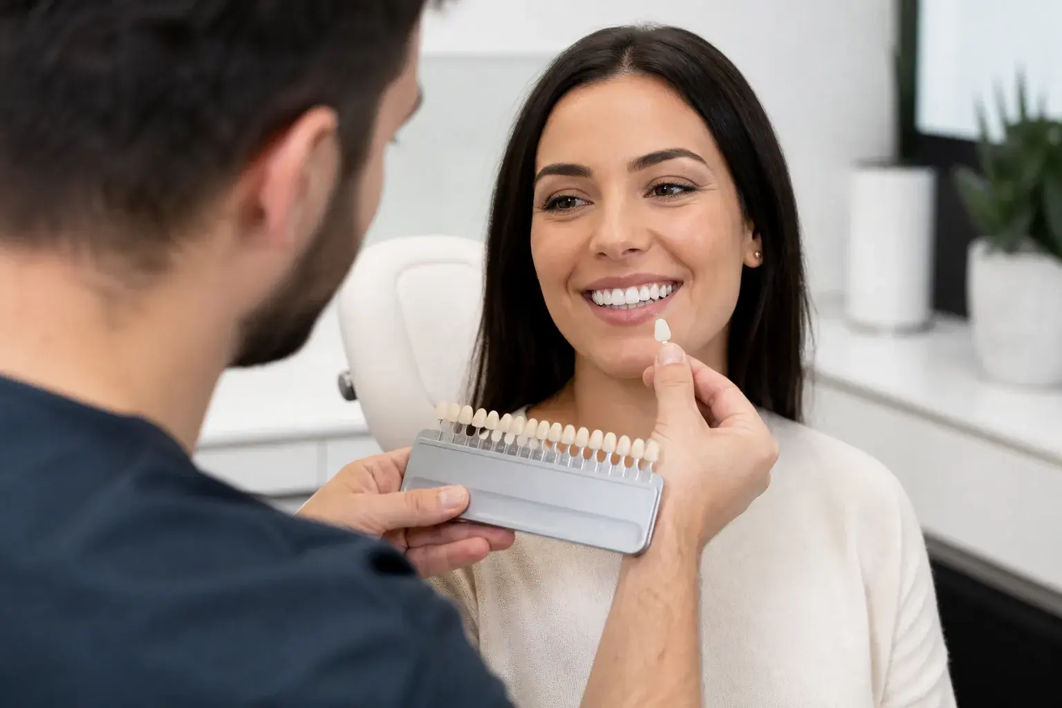 Veneer shade guide next to whitening trays showing why porcelain color stays unchanged