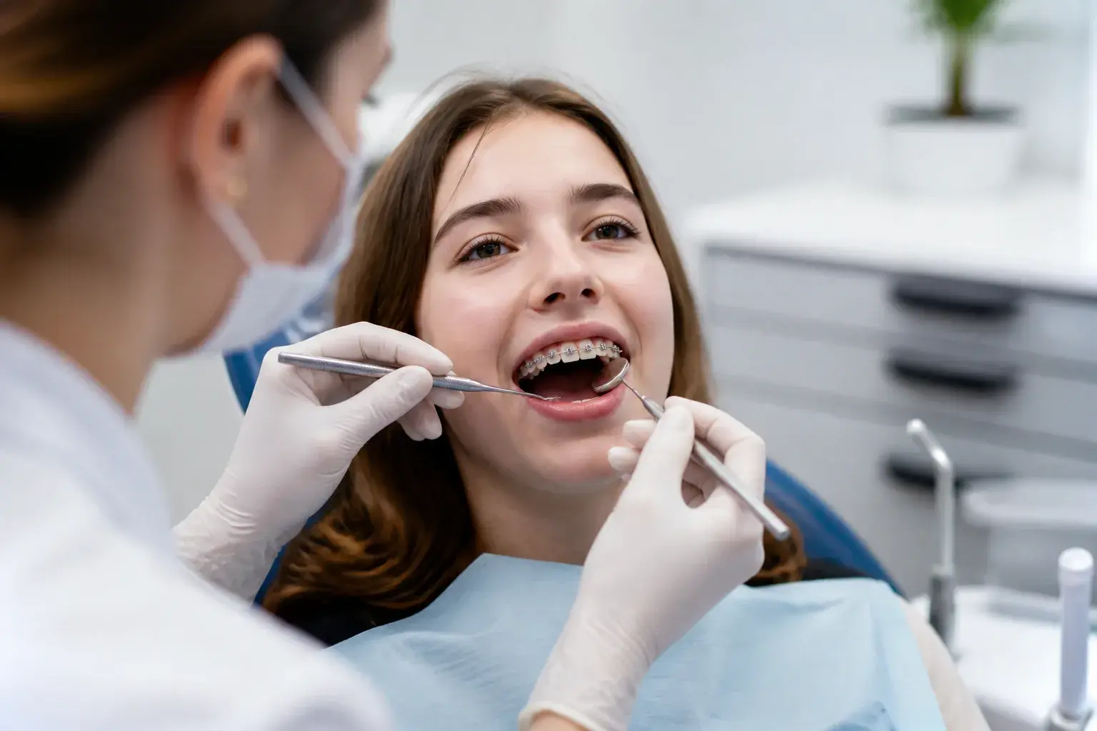 Close-up braces adjustment visit with orthodontic tools illustrating why teeth may feel sore after braces