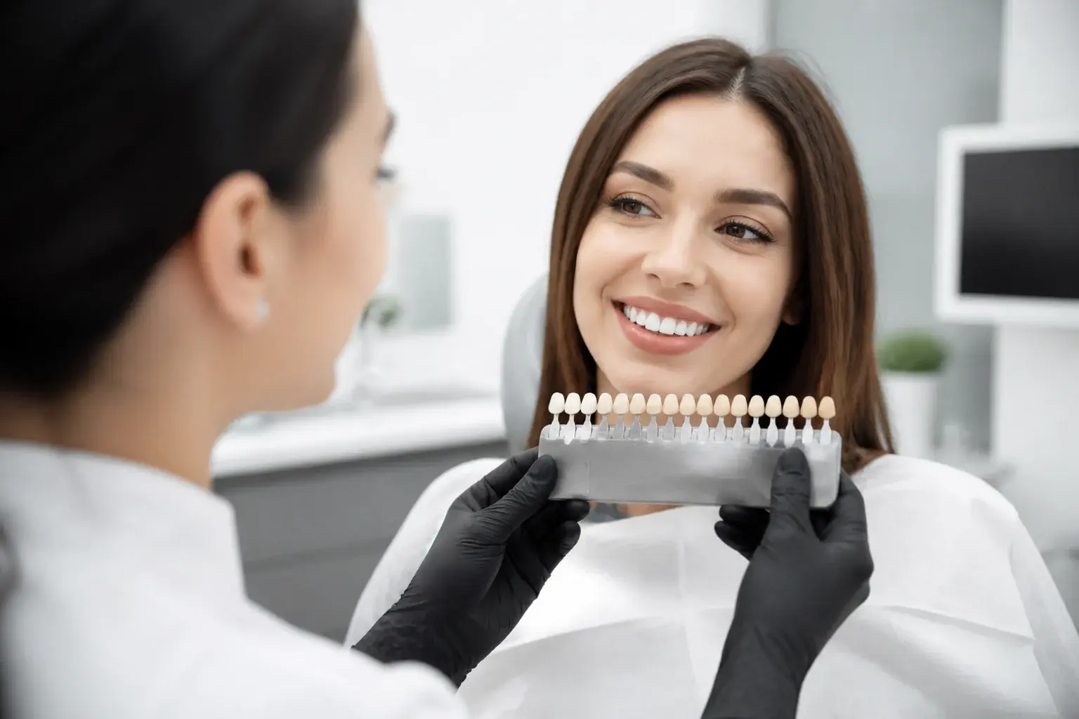 Charcoal toothpaste, toothbrush, and shade guide comparing charcoal claims with whitening results