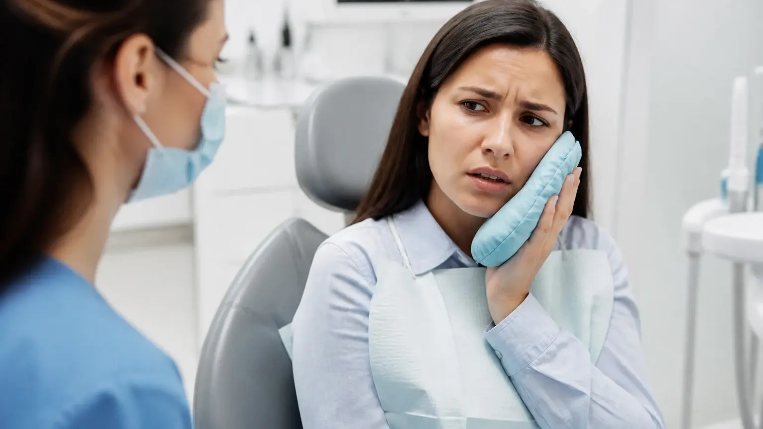 Concerned patient using an ice pack for toothache relief while awaiting a same-day dental visit