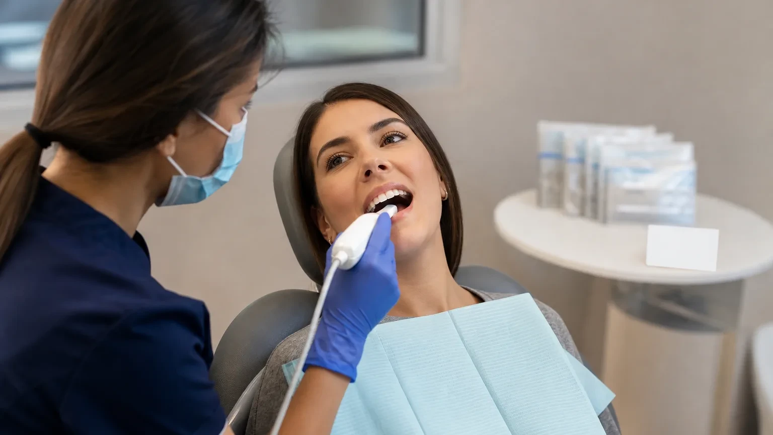 Dentist checking clear aligner fit and attachments at a progress visit