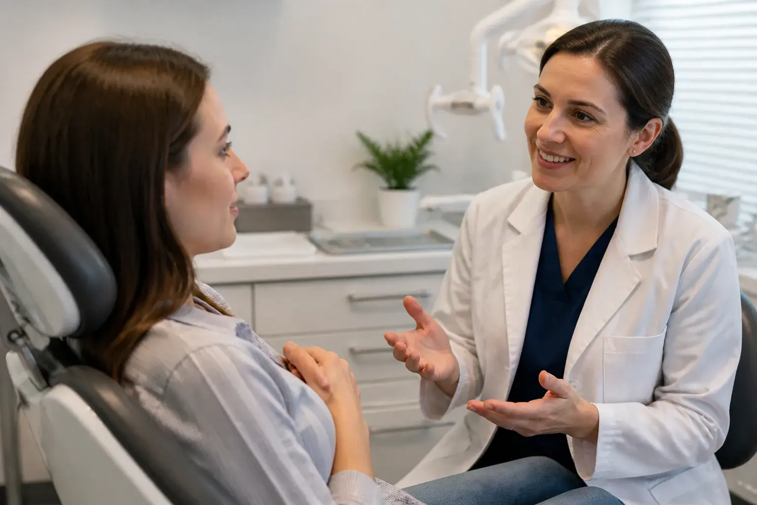 Patient researching anxiety-friendly dentists while a caring dental team explains comfort options