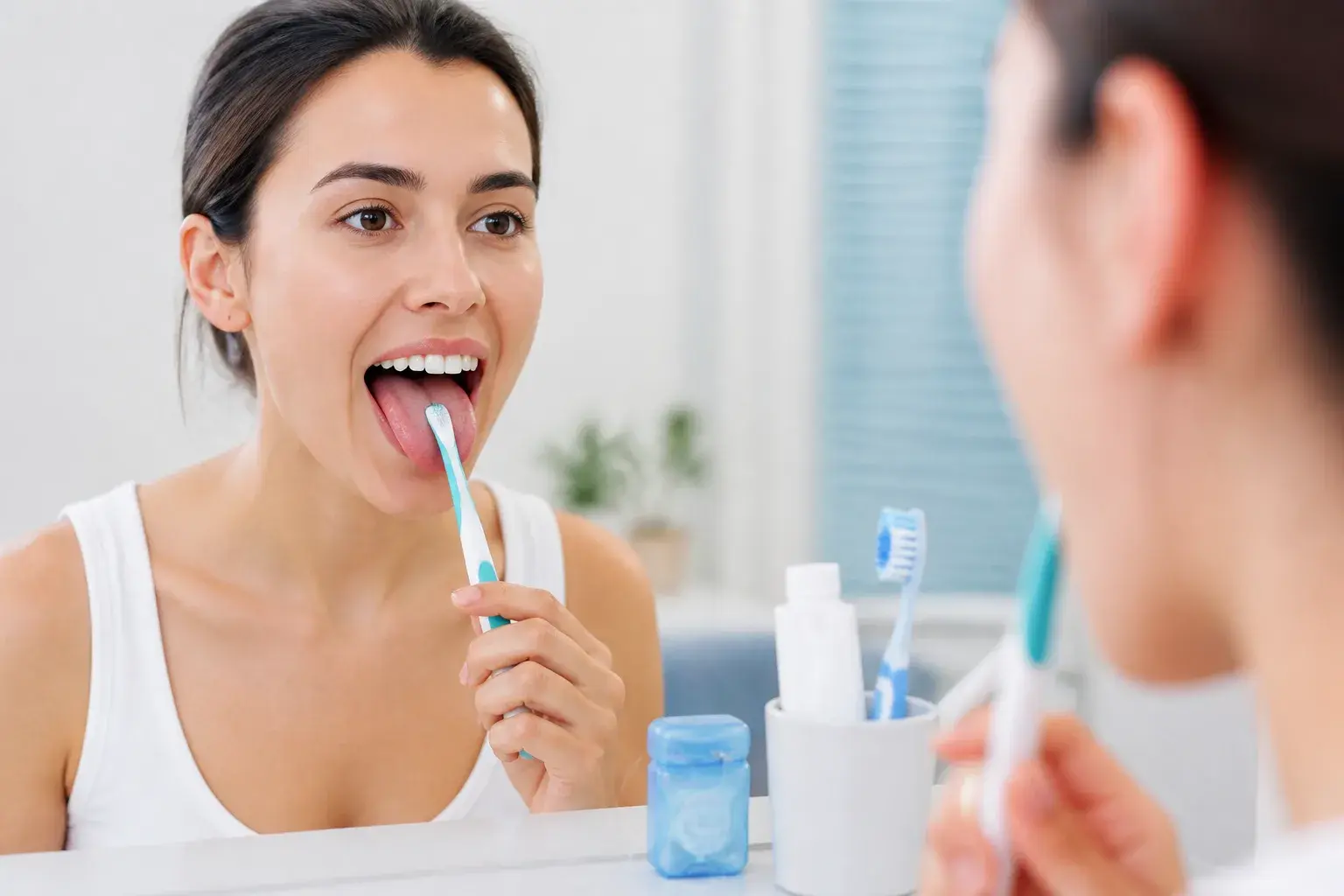 Tongue cleaner and toothbrush near oral care tools for fresh breath and tongue brushing guidance