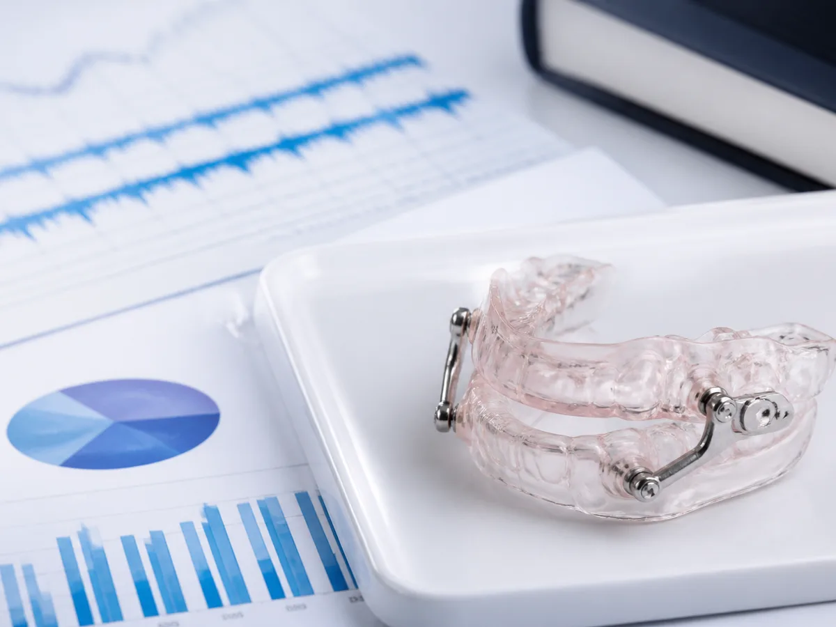 Patient and dentist reviewing a sleep-study summary before planning oral appliance care