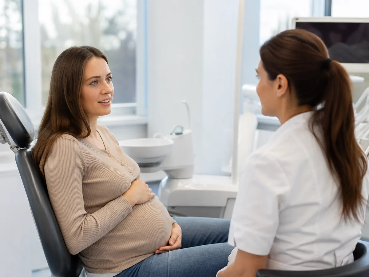 Pregnant dental patient reviewing a preventive care plan instead of whitening