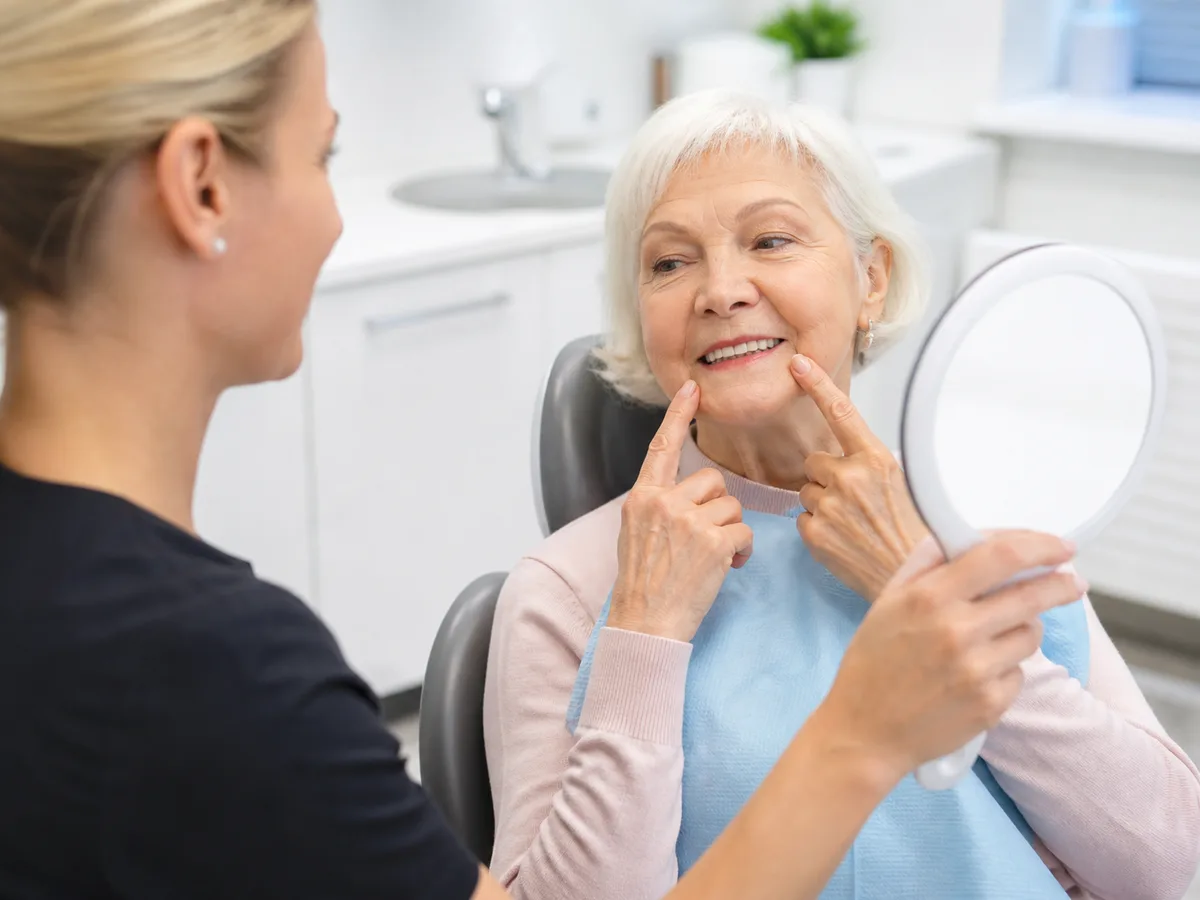 Denture try-in evaluating lip support and smile line in a mirror