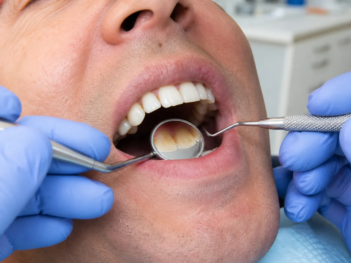 Patient holding a nightguard beside a crown care checklist