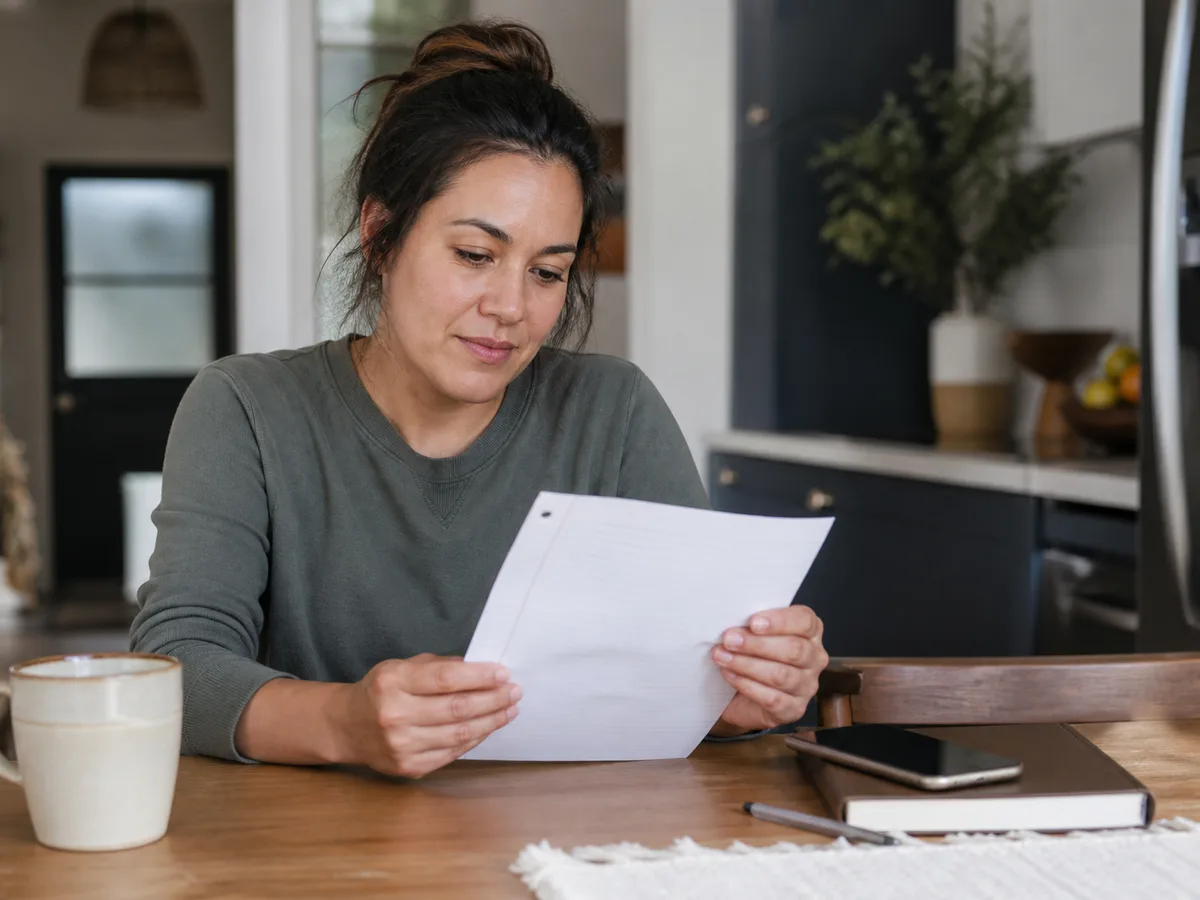 Patient and dentist reviewing cost phases and visit timelines on a printed plan