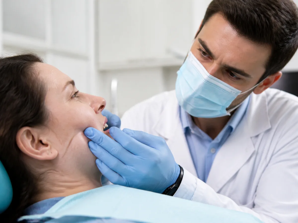 Dentist discusses extraction and root canal options with a patient