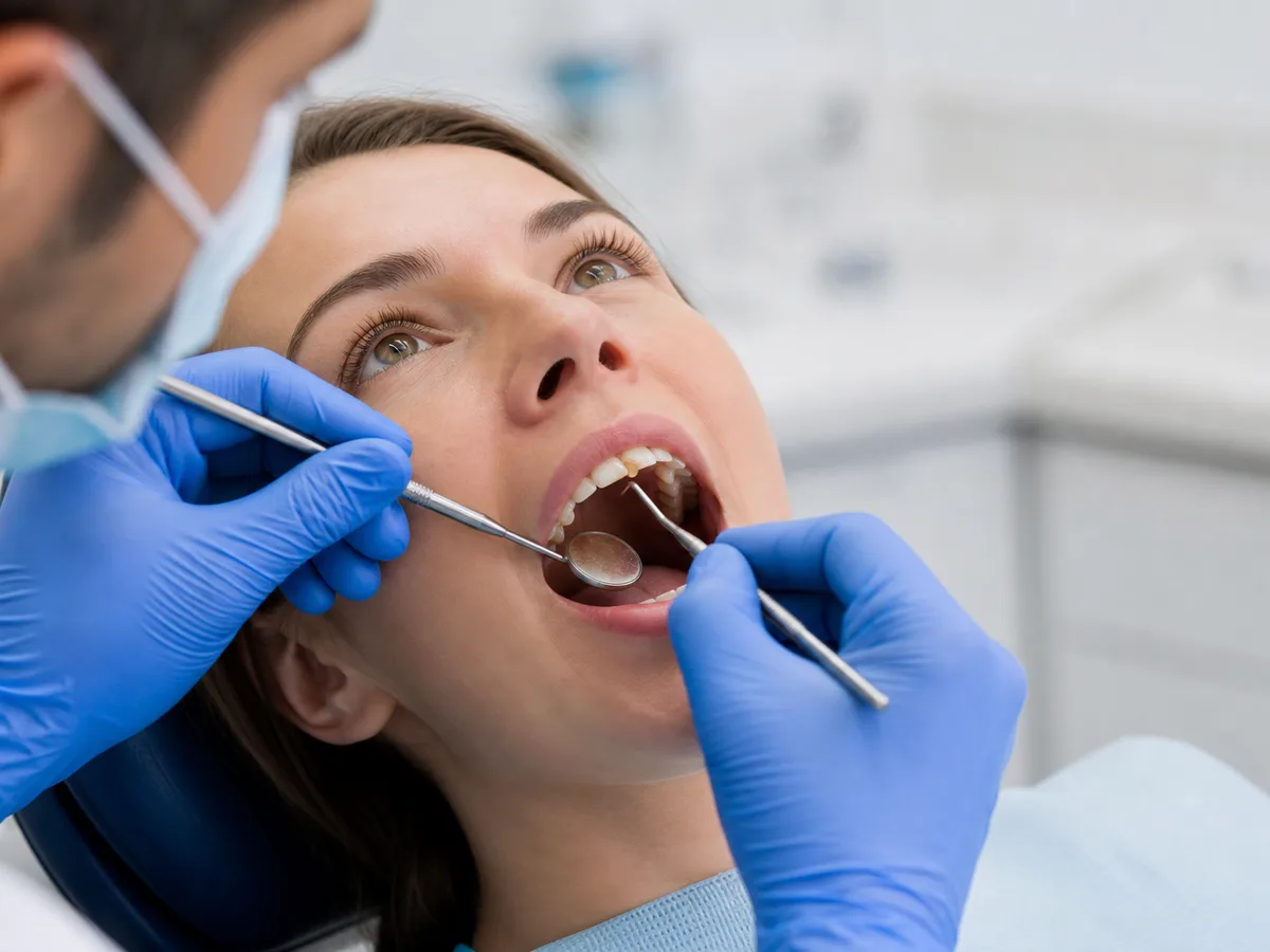 Dentist using bite paper and magnification to evaluate a cracked tooth