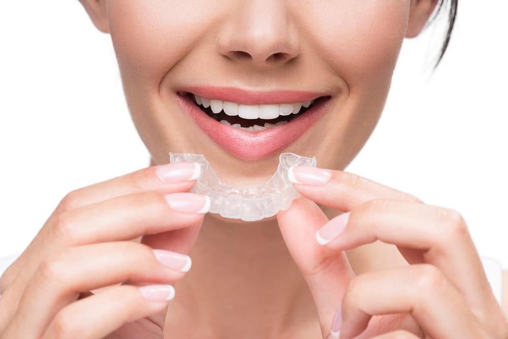 happy cheerful joyous woman holding aligners manicured nails pretty smile laugh lines