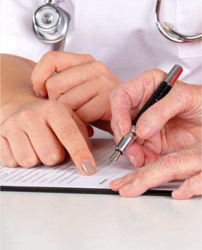 Patient signing a form