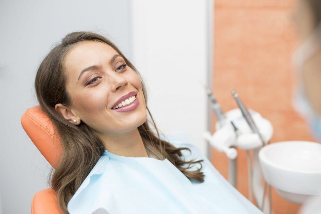 Beautiful Woman In A Dental Chair As A Patient Smiling