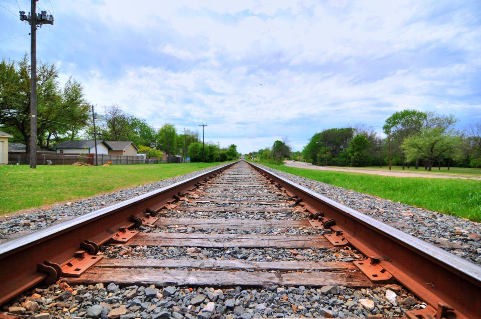 Railroad tracks and sky in wide angle.