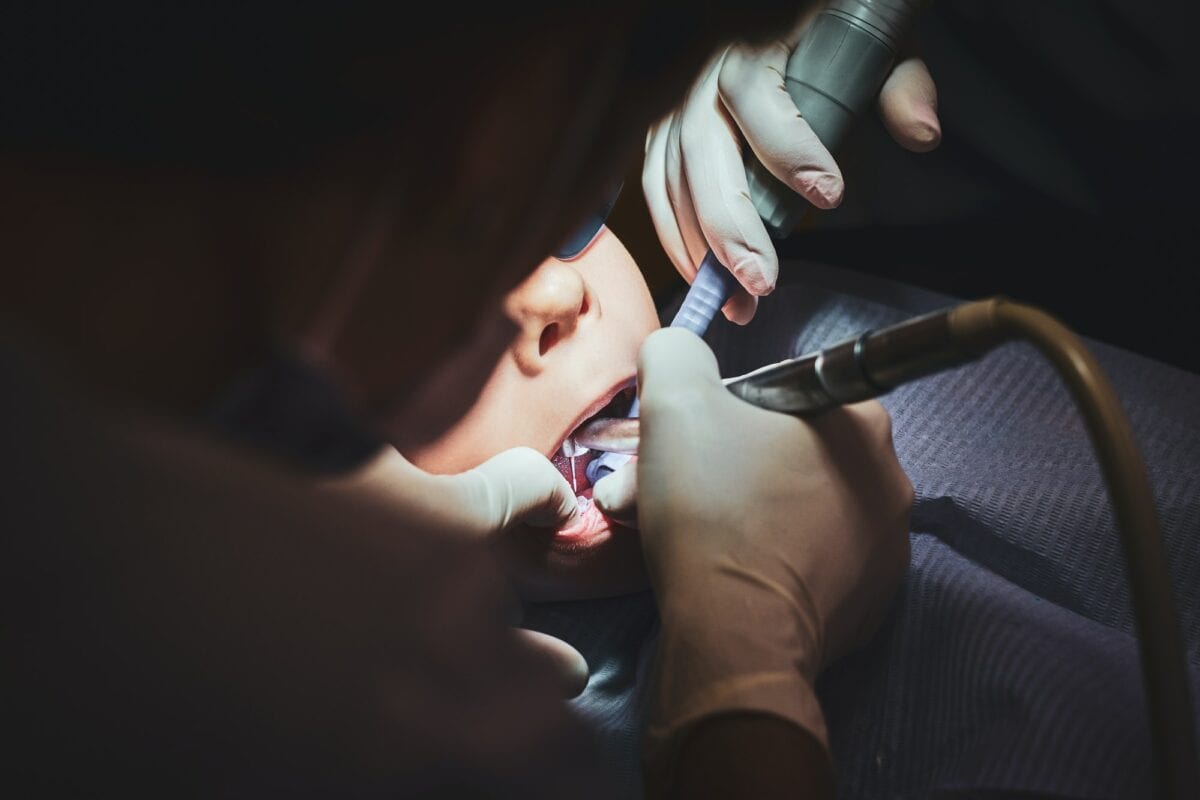 Process of dental operation for little boy