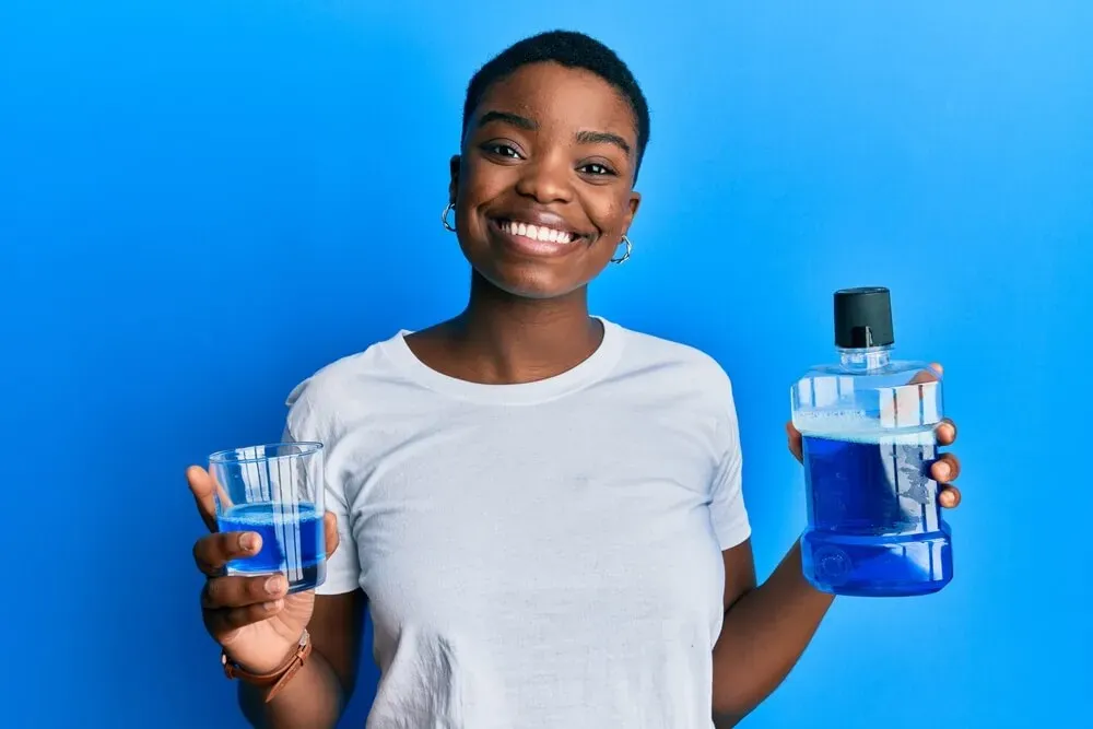 woman holding mouthwash