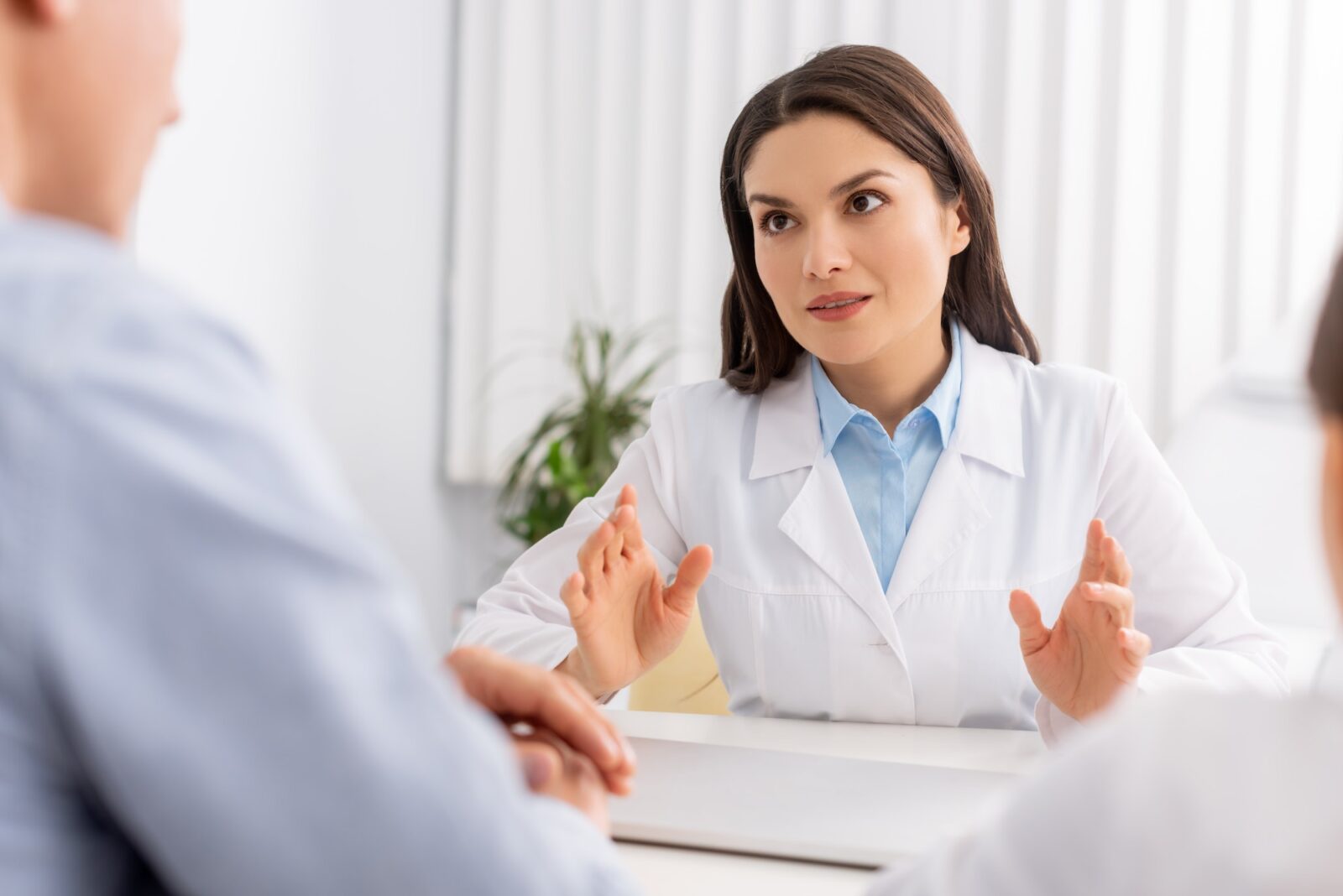 Selective focus of attractive ent physician talking to patients