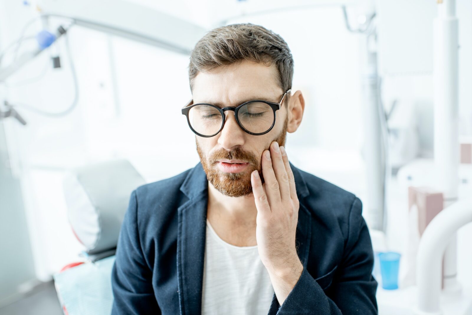 Businessman with toothache in the dental office