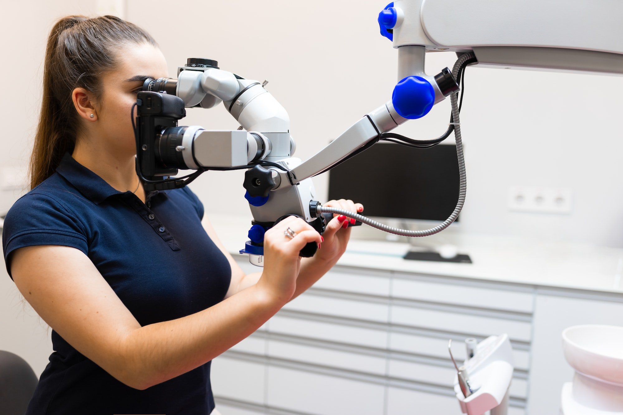 Dentist looks through the microscope. Modern dental equipment