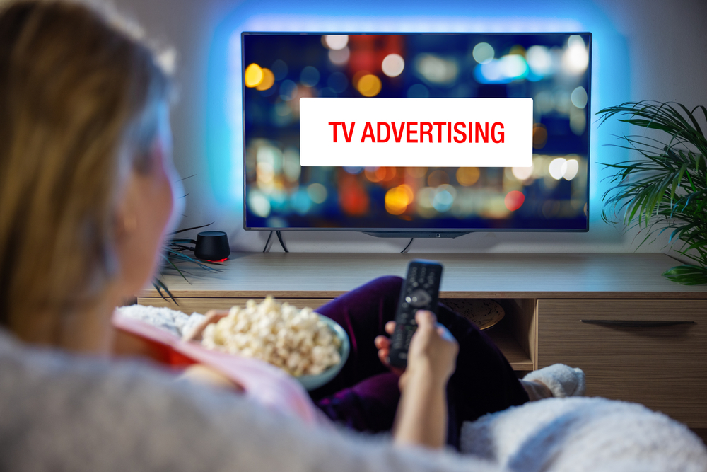 Woman watching a tv ad