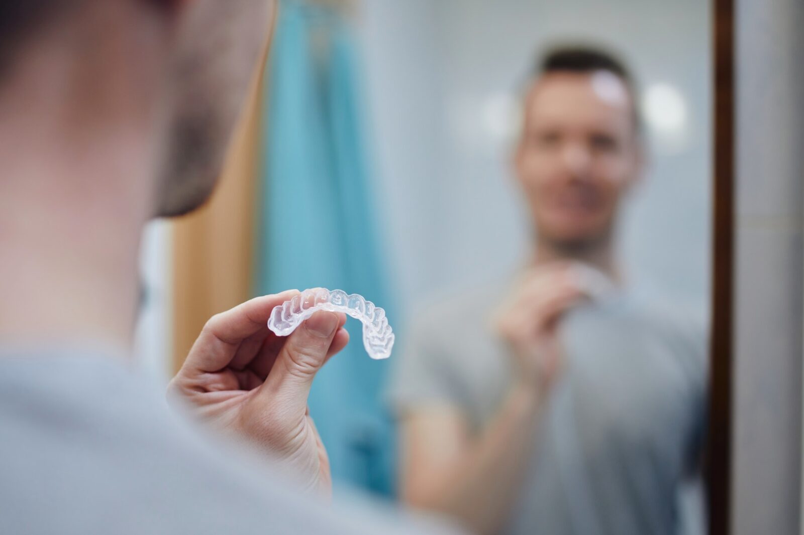 Man preparing silicon tray for teeth whitening