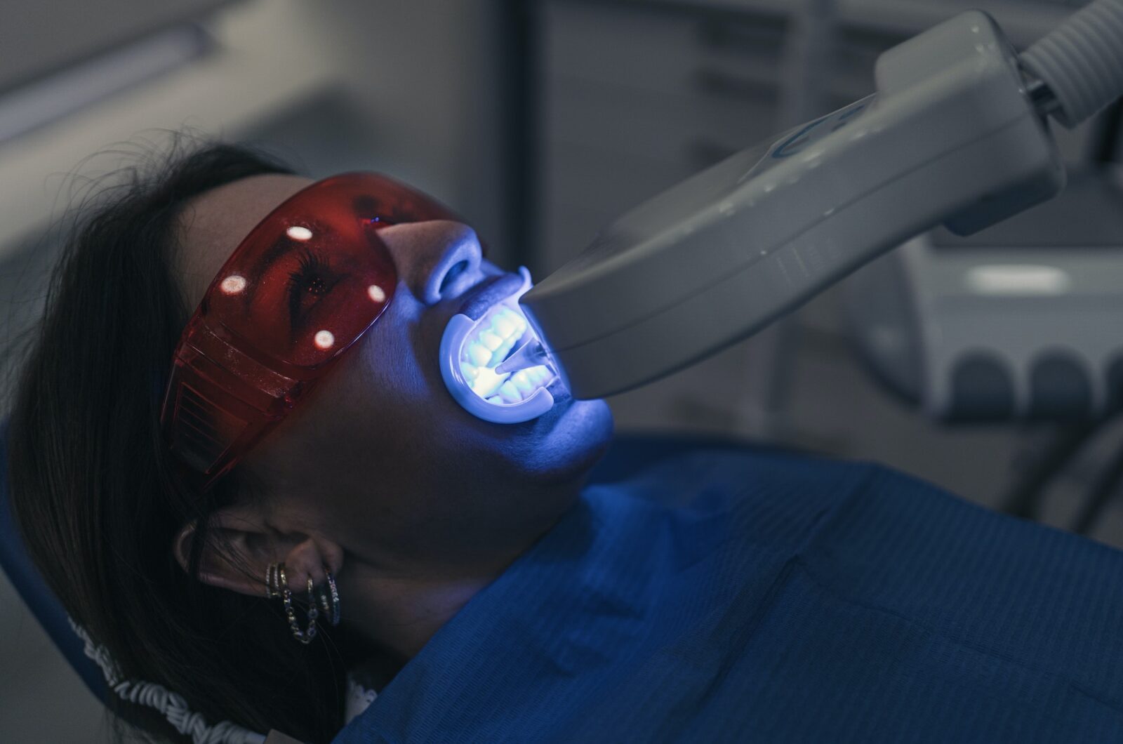 Woman doing tooth whitening treatment