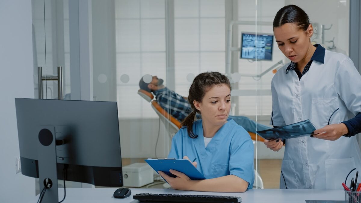 Professional team of dentist and nurse working on patient teethcare