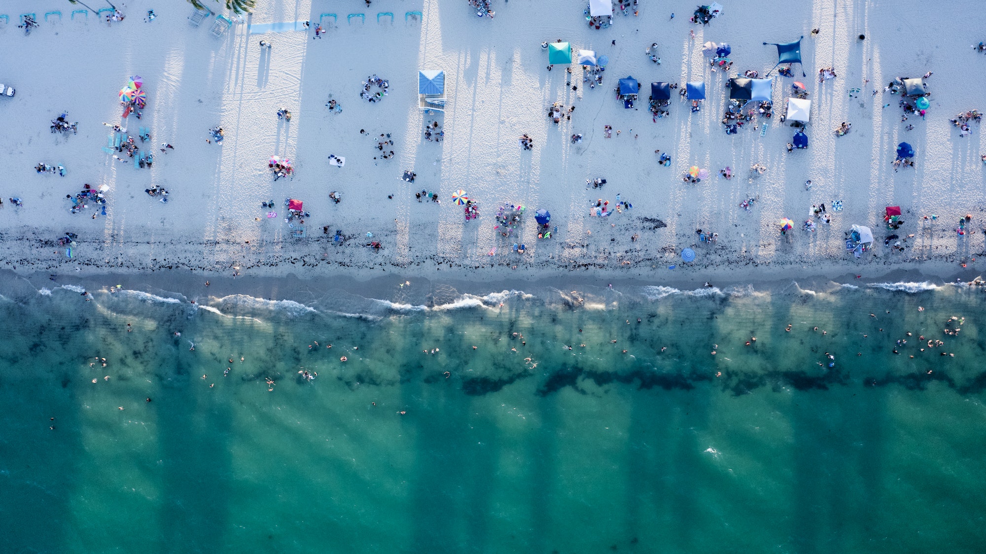 Aerial view of the Hollywood beach with people enjoying their time on a sunny day in Florida