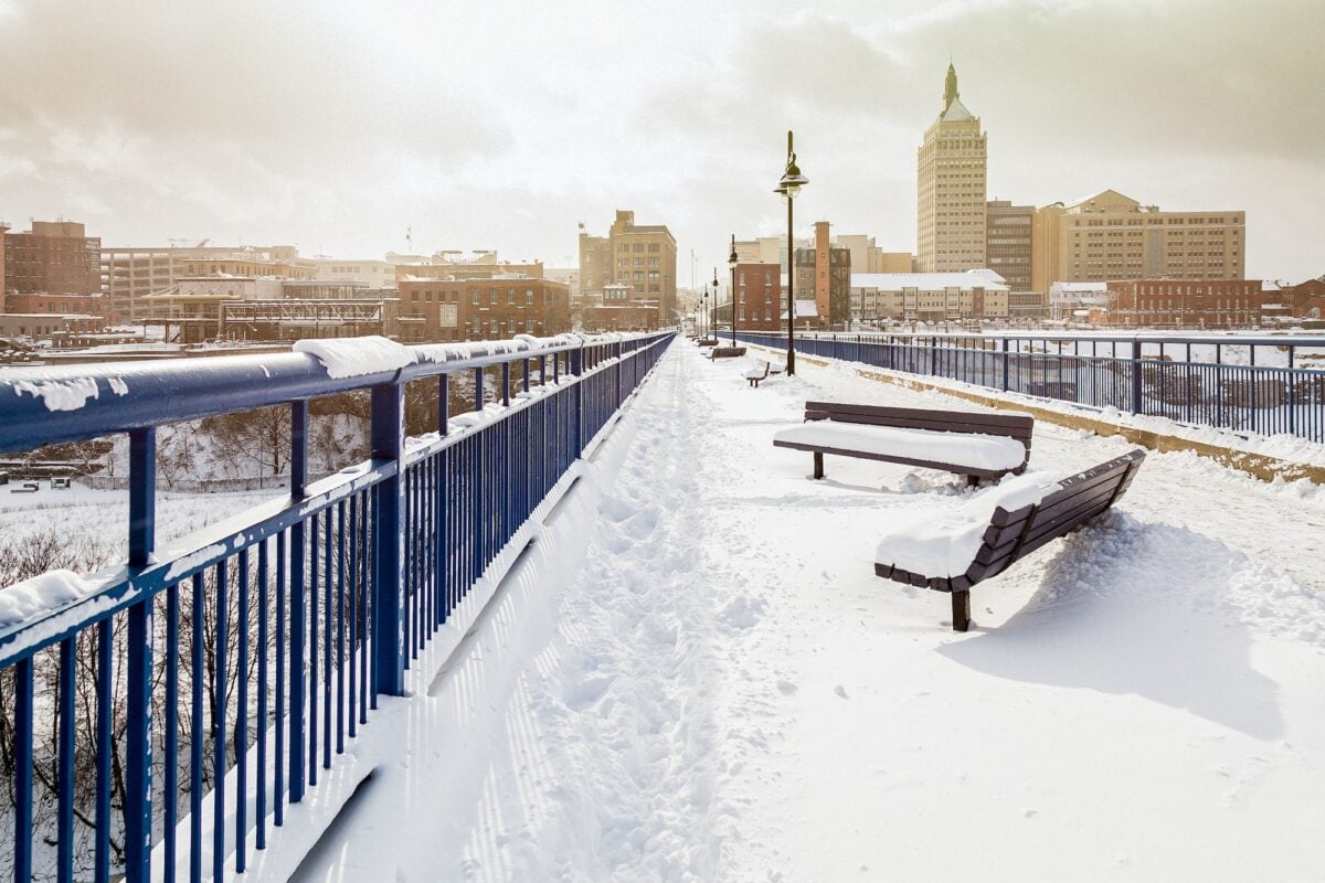 Beautiful shot of benches covered with snow at High Falls, Rochester, New York