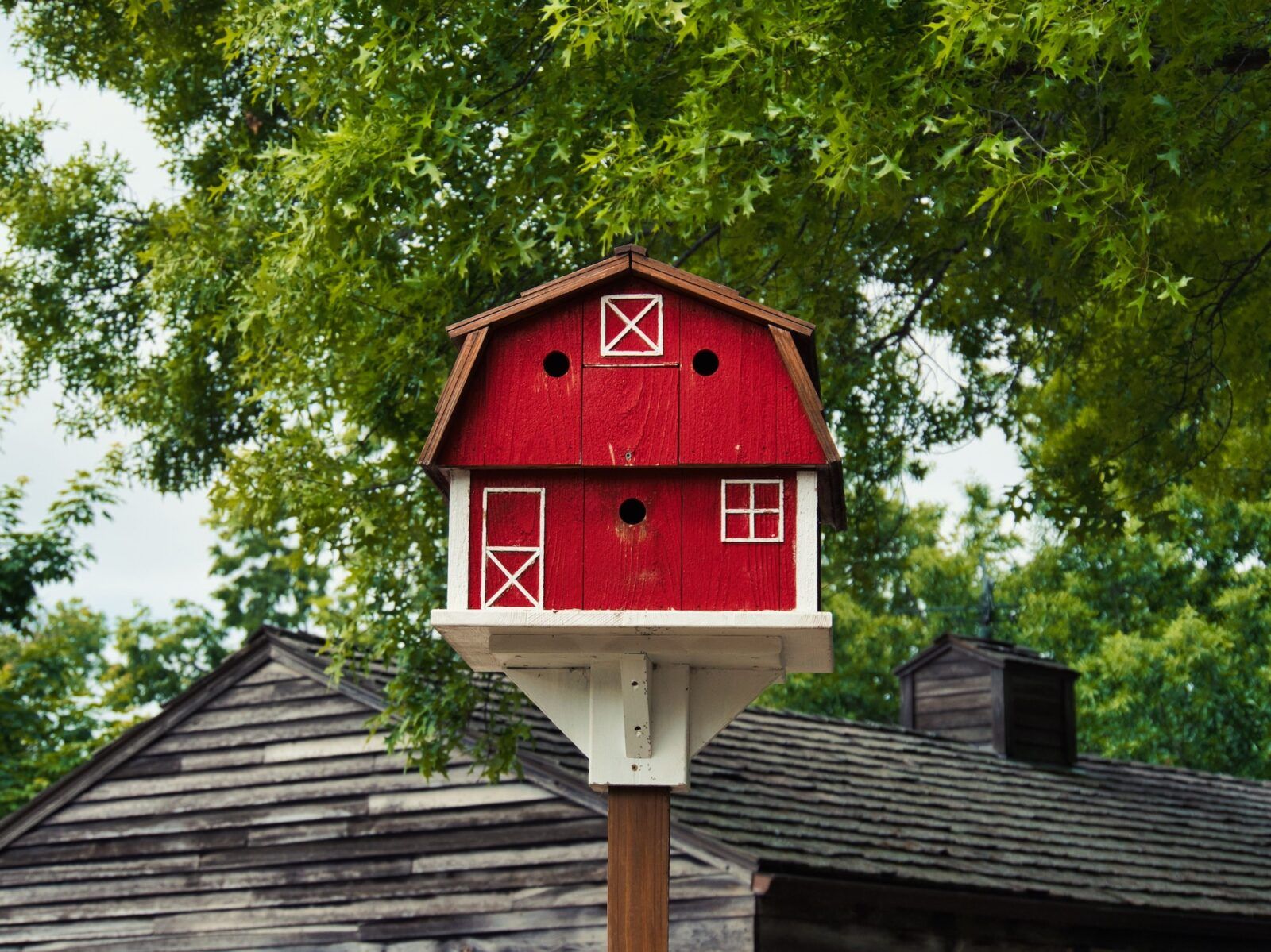 Closeup of a cute red barn birdhouse at Deanna Rose Farmstead in Overland park Kansas