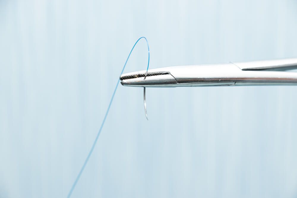 dental suture on a needle holder