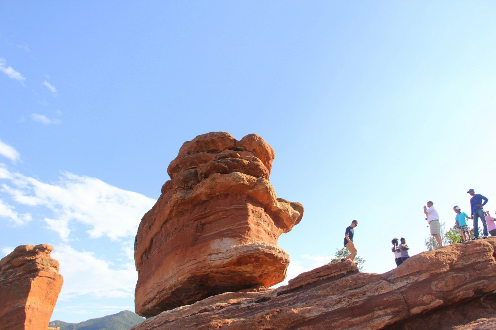 Hikers exploring on top of a rock formation at The Garden of the Gods Colorado Springs CO having fun
